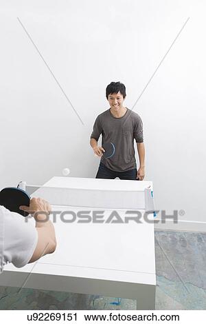 Happy Asian man playing ping pong with friend View Large Photo Image Stock Image - Happy Asian man playing ping pong with friend. Fotosearch