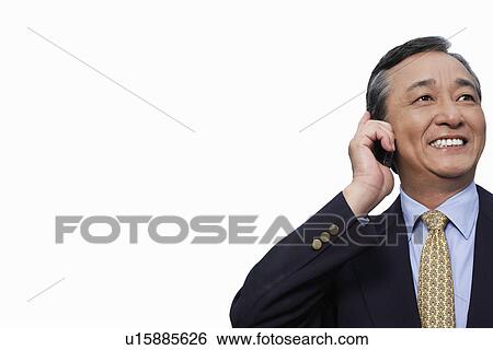 Happy businessman using cell phone over white background View Large Photo Image Stock Photograph - Happy businessman using cell phone over white background. Fotosearch