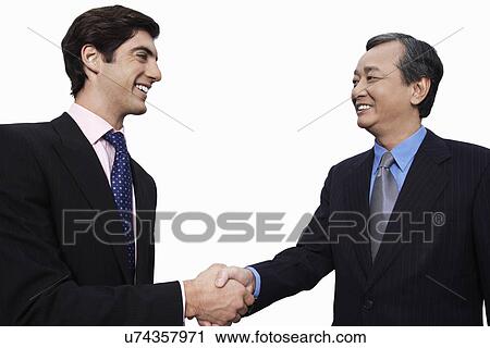 Stock Image - Happy businessmen shaking hands over white background. Fotosearch