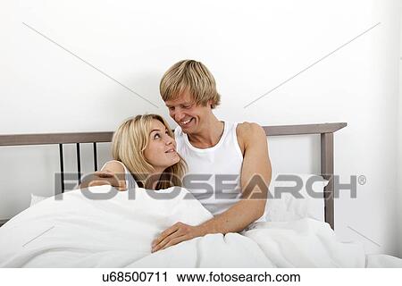 Happy couple looking at each other in bed View Large Photo Image Stock Image - Happy couple looking at each other in bed. Fotosearch