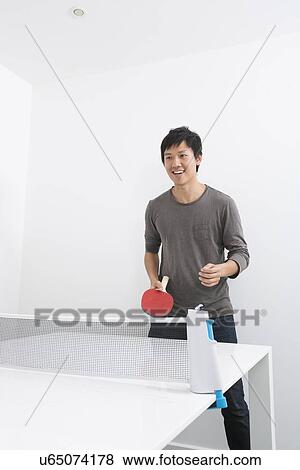 Happy mid adult man playing ping pong View Large Photo Image Stock Photo - Happy mid adult man playing ping pong. Fotosearch