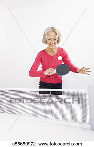 Happy senior woman playing table tennis View Large Photo Image Stock Image - Happy senior woman playing table tennis. Fotosearch