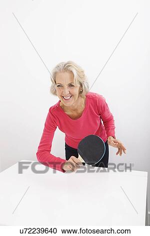 Happy senior woman playing table tennis View Large Photo Image Stock Image - Happy senior woman playing table tennis. Fotosearch