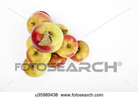 Stock Photo - High angle view of apples forming pyramid over white background. Fotosearch