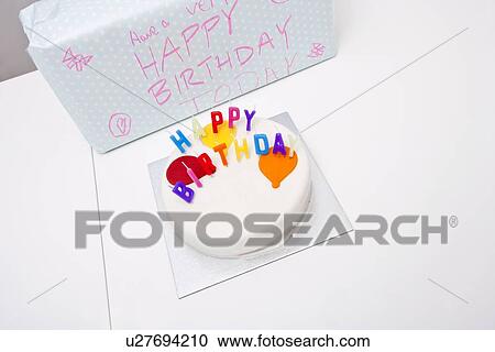 High angle view of birthday cake and gift on table View Large Photo Image Stock Image - High angle view of birthday cake and gift on table. Fotosearch