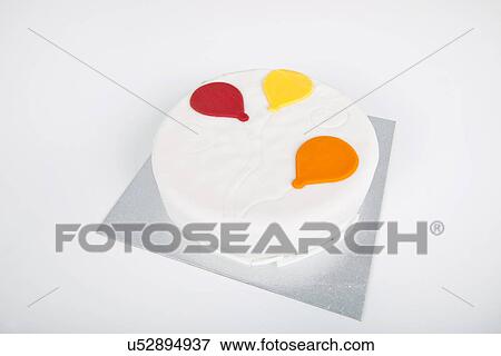 Stock Photo - High angle view of birthday cake over white background. Fotosearch