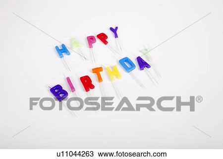 Stock Image - High angle view of birthday candles against white background. Fotosearch