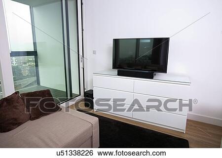 Stock Photograph - Interior of apartment with flat screen television. Fotosearch