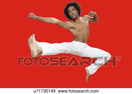 Kickboxer jumping over red background View Large Photo Image Stock Photo - Kickboxer jumping over red background. Fotosearch