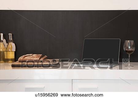 Laptop, wineglass and bread loaf on counter View Large Photo Image Stock Photo - Laptop, wineglass and bread loaf on counter. Fotosearch