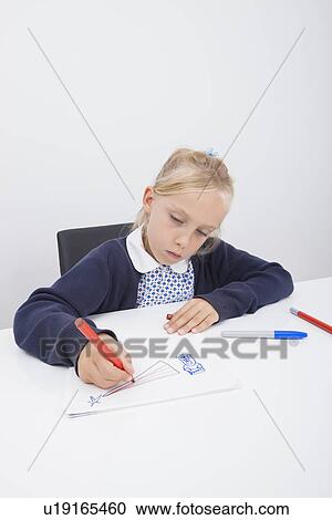 Little female student drawing on paper at table View Large Photo Image Stock Image - Little female student drawing on paper at table. Fotosearch