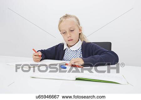 Stock Photo - Little girl drawing on paper at table. Fotosearch