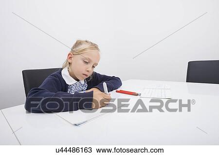 Little girl drawing on paper with felt tip pen at table View Large Photo Image Stock Image - Little girl drawing on paper with felt tip pen at table. Fotosearch