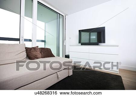 Living room with flat screen television in apartment View Large Photo Image Stock Photograph - Living room with flat screen television in apartment. Fotosearch