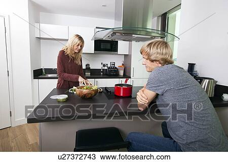 Man looking at woman cutting vegetable in kitchen View Large Photo Image Stock Image - Man looking at woman cutting vegetable in kitchen. Fotosearch