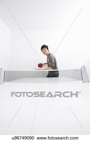 Mid adult man playing table tennis View Large Photo Image Stock Image - Mid adult man playing table tennis. Fotosearch