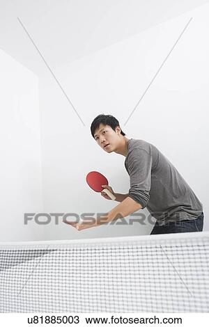 Mid adult man preparing to serve table tennis ball View Large Photo Image Stock Image - Mid adult man preparing to serve table tennis ball. Fotosearch
