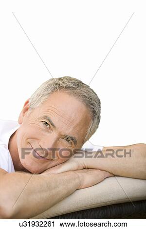 Middle-aged man relaxing on deck chair in garden portrait View Large Photo Image Stock Image - Middle-aged man relaxing on deck chair in garden portrait. Fotosearch