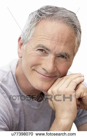 Stock Image - Middle-aged man sitting by pool portrait. Fotosearch