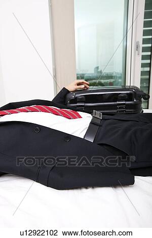 Midsection of businessman with luggage lying in bed at home View Large Photo Image Stock Image - Midsection of businessman with luggage lying in bed at home. Fotosearch