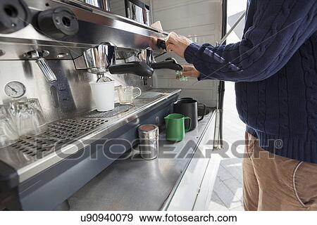 Midsection of man cleaning coffee machine at mobile shop View Large Photo Image Stock Photo - Midsection of man cleaning coffee machine at mobile shop. Fotosearch
