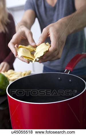 Midsection of man cooking pasta View Large Photo Image Stock Photo - Midsection of man cooking pasta. Fotosearch