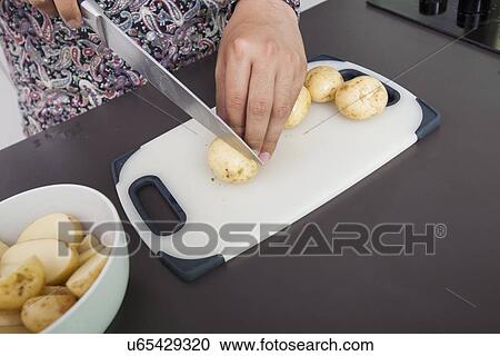 Midsection of man cutting potato at kitchen counter View Large Photo Image Stock Image - Midsection of man cutting potato at kitchen counter. Fotosearch