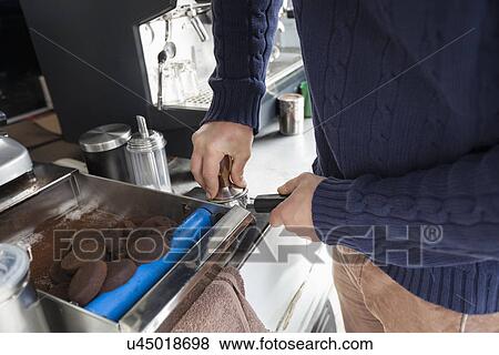 Stock Photo - Midsection of man preparing coffee at mobile coffee shop. Fotosearch