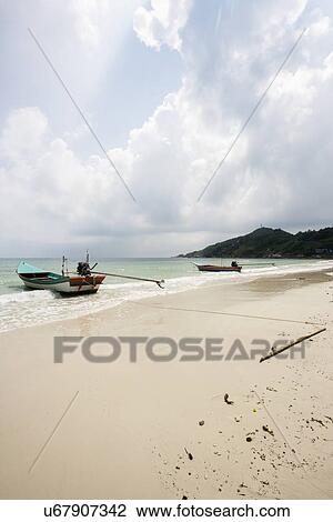 Stock Image - Motorboats on beach, Koh Pha Ngan, Thailand. Fotosearch