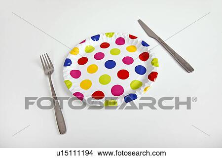 Multicolored plate with polka dots and cutlery over white background View Large Photo Image Picture - Multicolored plate with polka dots and cutlery over white background. Fotosearch