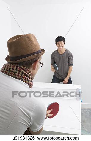 Multiethnic friends playing table tennis View Large Photo Image Stock Photograph - Multiethnic friends playing table tennis. Fotosearch