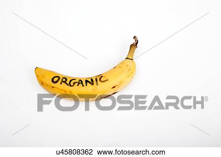 Stock Image - Organic banana against white background. Fotosearch