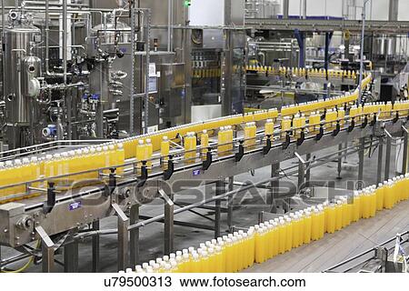 Packed bottles moving on conveyor belt in bottling industry View Large Photo Image Stock Image - Packed bottles moving on conveyor belt in bottling industry. Fotosearch