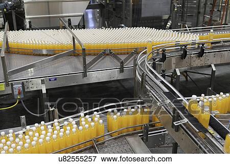 Packed bottles moving on conveyor belt View Large Photo Image Stock Photo - Packed bottles moving on conveyor belt. Fotosearch