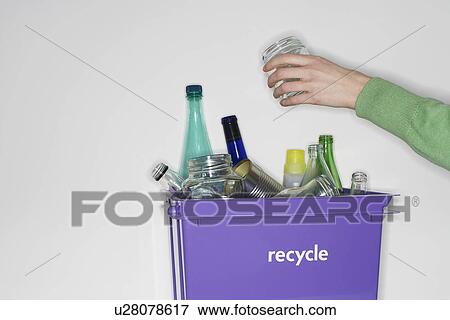 Person putting jar into recycling container filled with empty glass vessels View Large Photo Image Stock Photo - Person putting jar into recycling container filled with empty glass vessels. Fotosearch