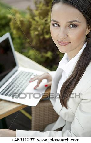 Portrait of beautiful businesswoman using laptop outdoors View Large Photo Image Stock Photo - Portrait of beautiful businesswoman using laptop outdoors. Fotosearch