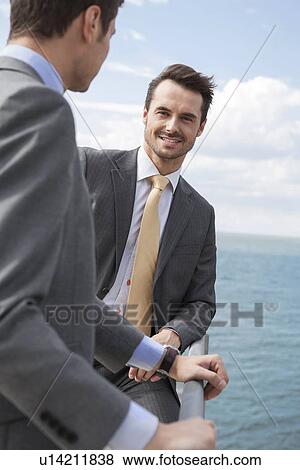 Stock Photo - Portrait of businessman with coworker on terrace. Fotosearch