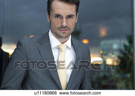 Stock Photo - Portrait of confident businessman in office. Fotosearch