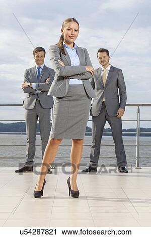 Portrait of confident businesswoman standing with coworkers on terrace against sky View Large Photo Image Stock Image - Portrait of confident businesswoman standing with coworkers on terrace against sky. Fotosearch
