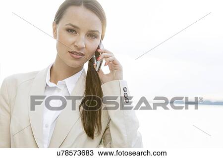 Portrait of confident businesswoman using cell phone outdoors View Large Photo Image Stock Image - Portrait of confident businesswoman using cell phone outdoors. Fotosearch