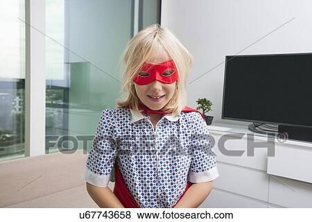Portrait of cute girl in super hero costume at home View Large Photo Image Stock Photo - Portrait of cute girl in super hero costume at home. Fotosearch