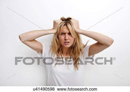 Portrait of frustrated woman pulling against white background View Large Photo Image Stock Photo - Portrait of frustrated woman pulling against white background. Fotosearch