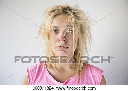 Picture - Portrait of frustrated woman suffering from cold against gray background. Fotosearch