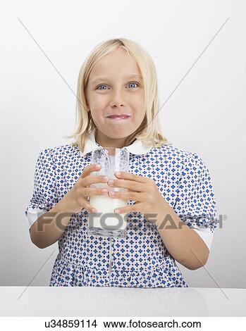 Portrait of girl drinking milk View Large Photo Image Picture - Portrait of girl drinking milk. Fotosearch