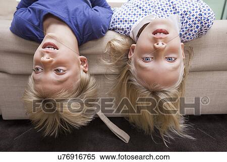 Portrait of girl with brother lying on sofa bed View Large Photo Image Stock Photography - Portrait of girl with brother lying on sofa bed. Fotosearch