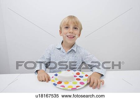 Portrait of happy boy with cake slice in plate on table at home View Large Photo Image Stock Photography - Portrait of happy boy with cake slice in plate on table at home. Fotosearch