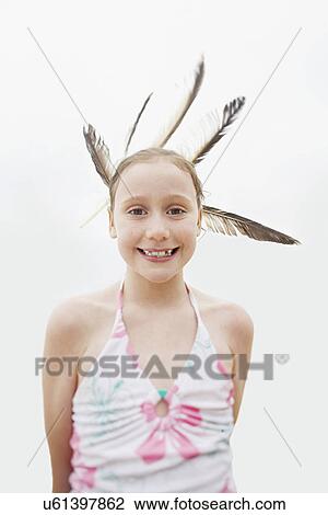 Portrait of happy girl with feathers in hair over white background View Large Photo Image Stock Image - Portrait of happy girl with feathers in hair over white background. Fotosearch