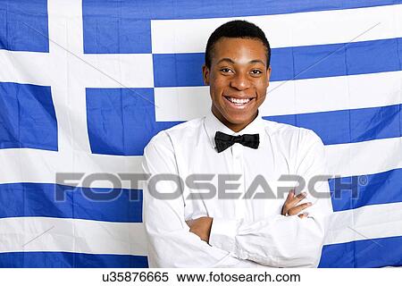 Portrait of happy man with arms crossed against Greek flag View Large Photo Image Stock Photography - Portrait of happy man with arms crossed against Greek flag. Fotosearch
