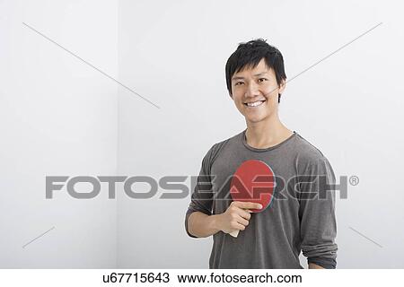 Portrait of happy mid adult man holding table tennis paddle View Large Photo Image Stock Image - Portrait of happy mid adult man holding table tennis paddle. Fotosearch
