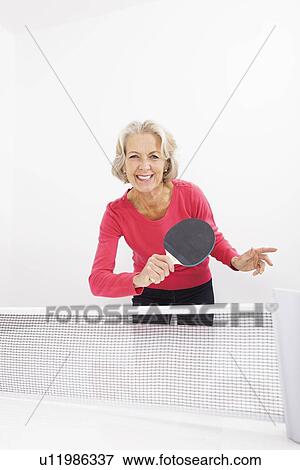 Portrait of happy senior woman playing table tennis View Large Photo Image Stock Photo - Portrait of happy senior woman playing table tennis. Fotosearch